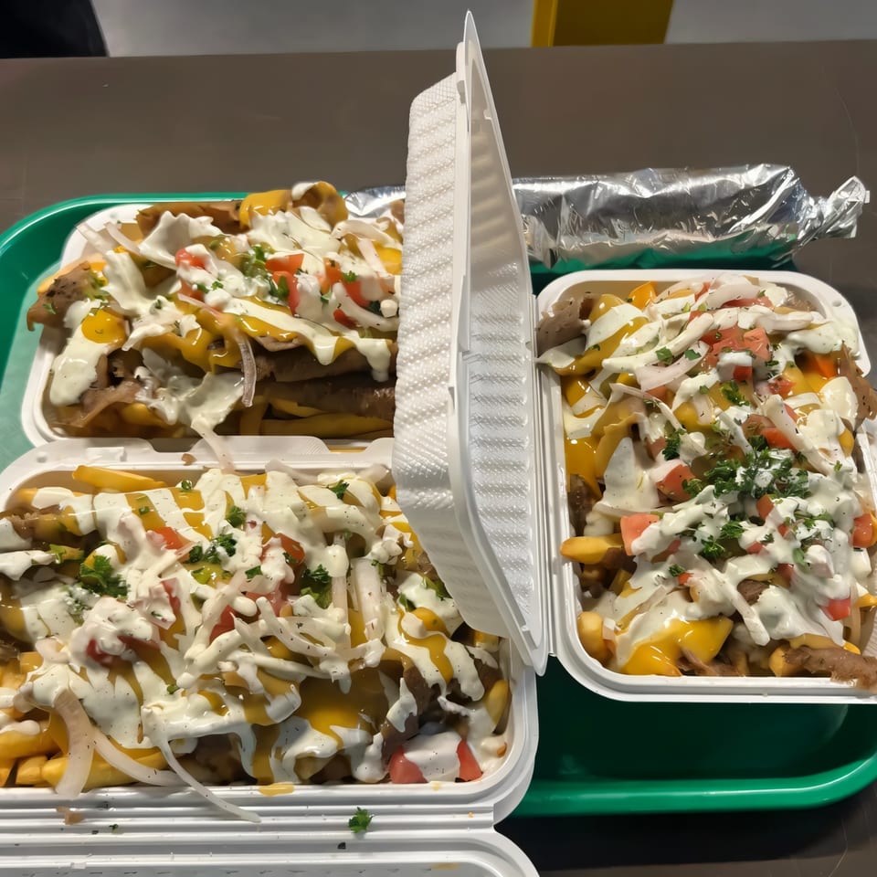 Three Mazaj Mediterranean gyro fry platters with meat, cheese, white sauce, and vegetables.